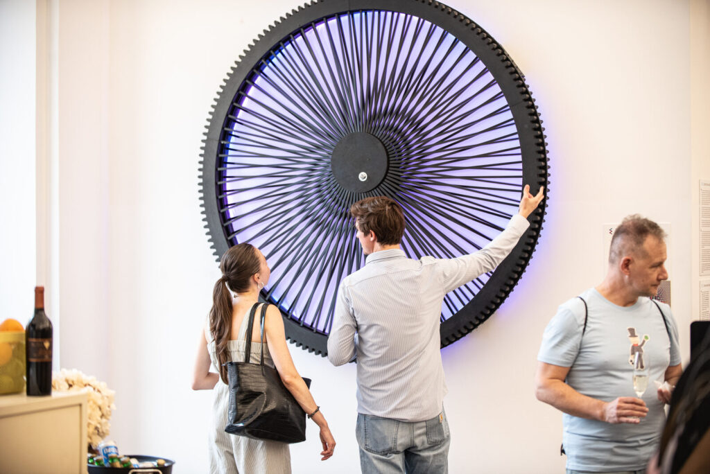 Visitors in front of the kinetic artwork Infinity by Florian Goerlitz at IAM (Image: Prague Morning (Florian Goerlitz, Infinity))