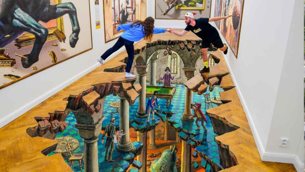 Visitors posing on a three-dimensional floor illusion at Illusion Art Museum Prague (Image: Prague Morning)