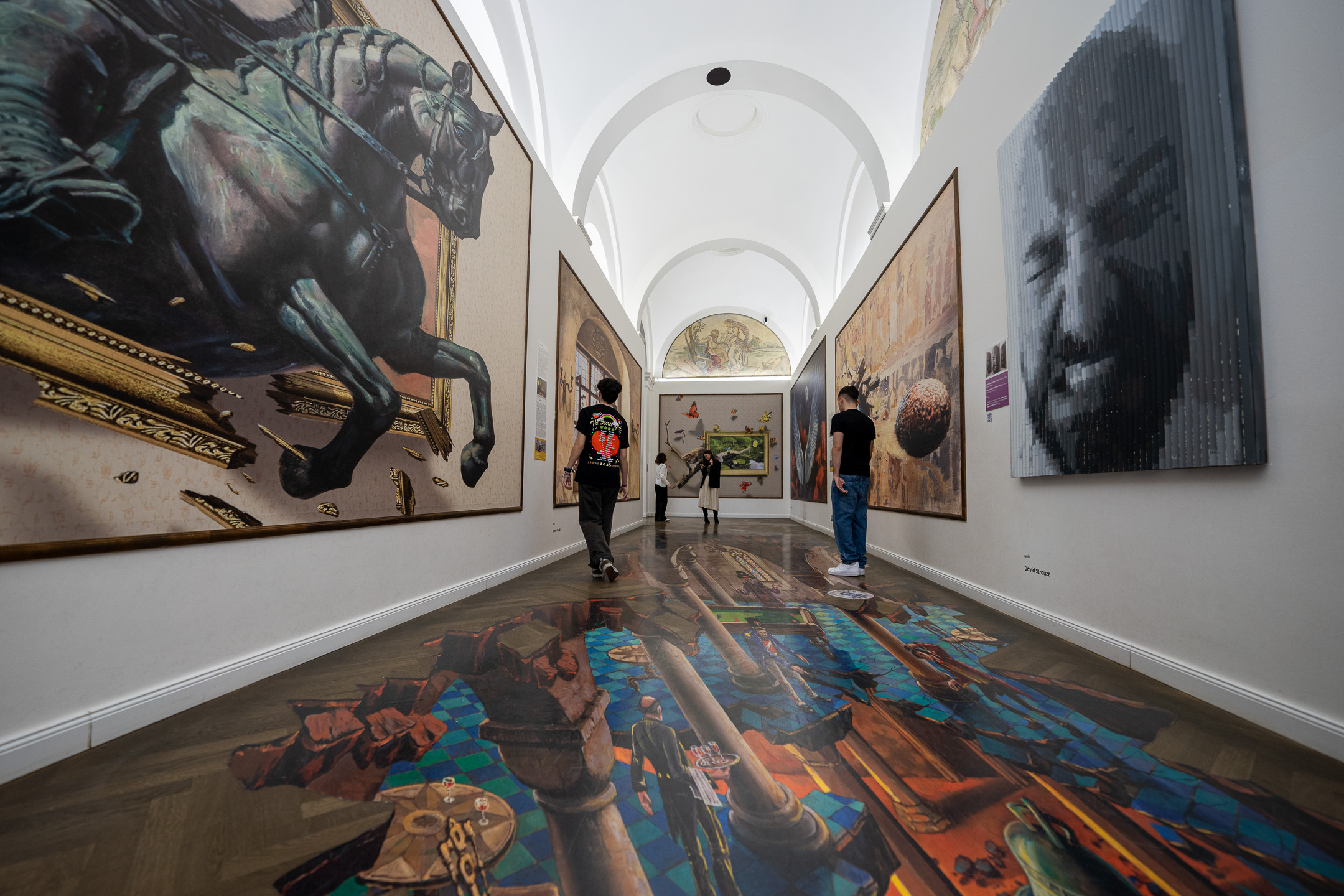 Vaulted corridor with a 3D floor painting and large illusion paintings